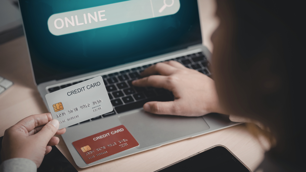 Person entering credit card details while shopping online on laptop computer